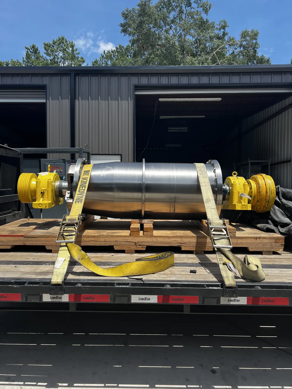 Repaired industrial centrifuge loaded for delivery from KMS